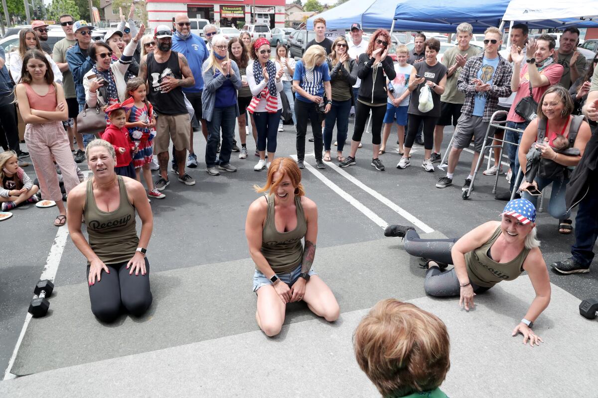 Participants catch their breath after doing push-ups for 90 seconds during the 10th annual Pushups for Charity event.