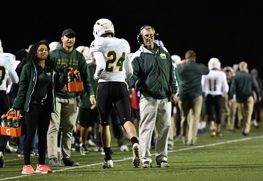 Edison's Jack Carmichael is congratulated by coach Dave White after scoring a touchdown in the first half of the CIF Southern Section Division 3 championship game at La Mirada High School on Friday.