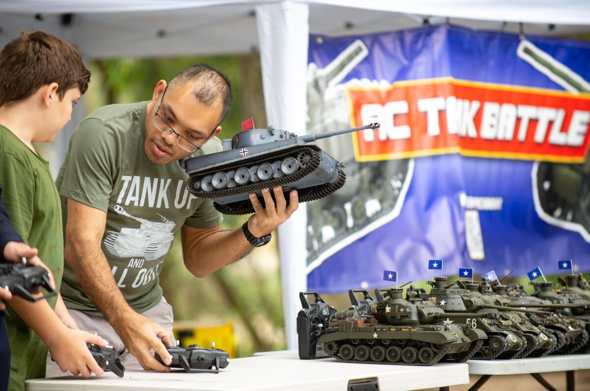 Tang Manisuta checks for mechanical issues of a toy tank.