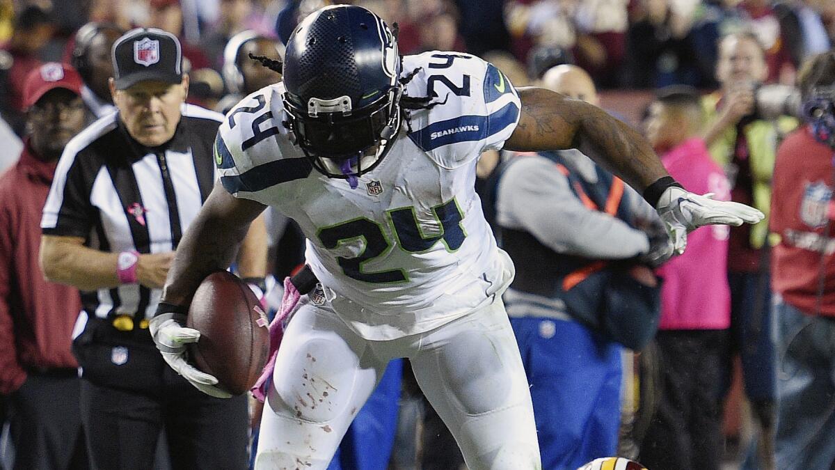 Seattle Seahawks running back Marshawn Lynch breaks a tackle while on his way to scoring a touchdown during the second half of a 27-17 victory over the Washington Redskins on Monday.