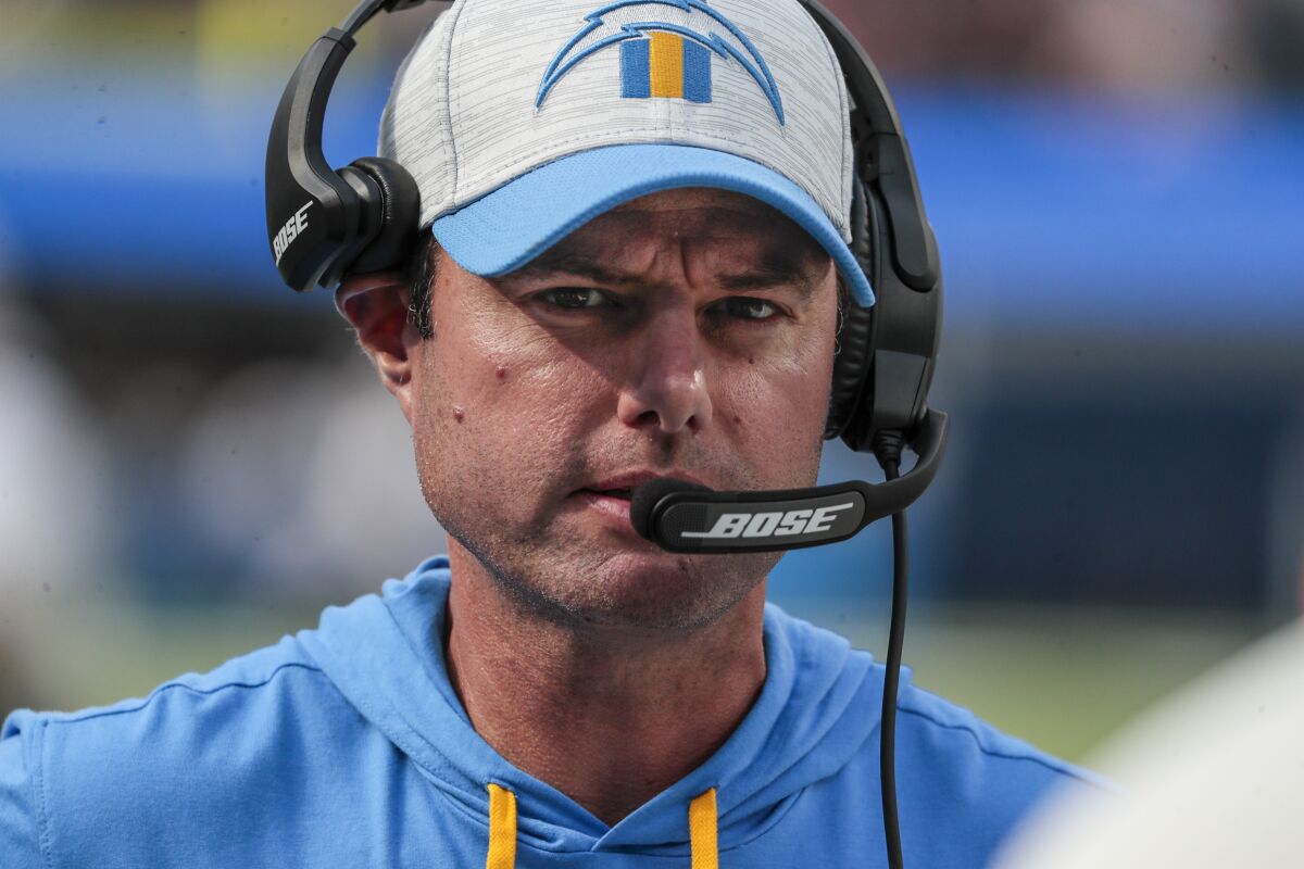 Chargers head coach Brandon Staley wears a headset on the sideline.