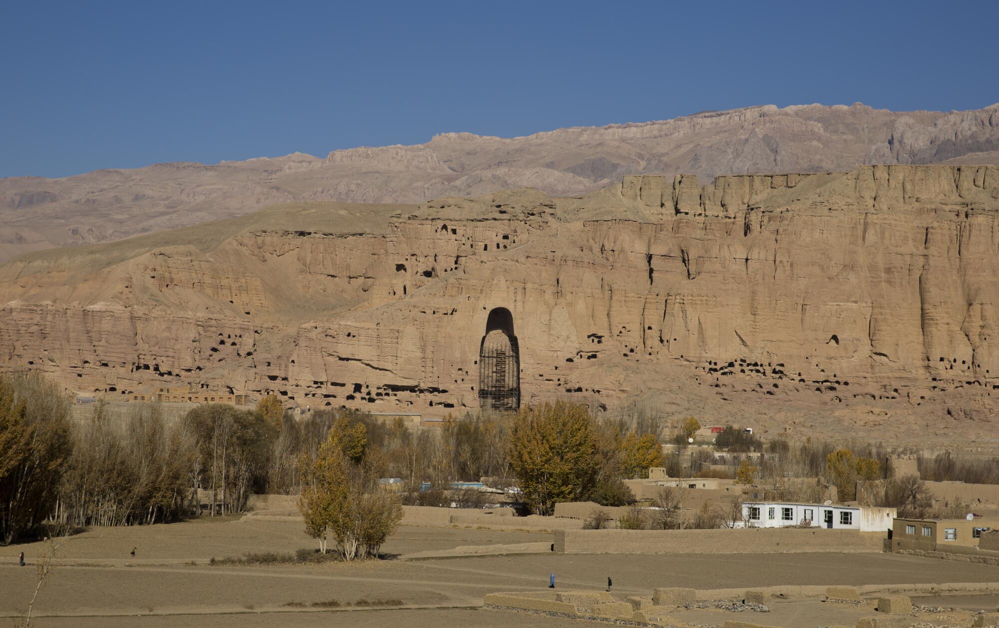 A towering gap in a mountain reveals a niche where one of the great Buddhas of Bamian once stood