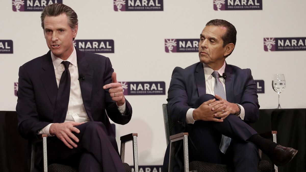 Democratic candidates for governor Gavin Newsom, left, and Antonio Villaraigosa participate in a forum in San Francisco on Jan. 30.