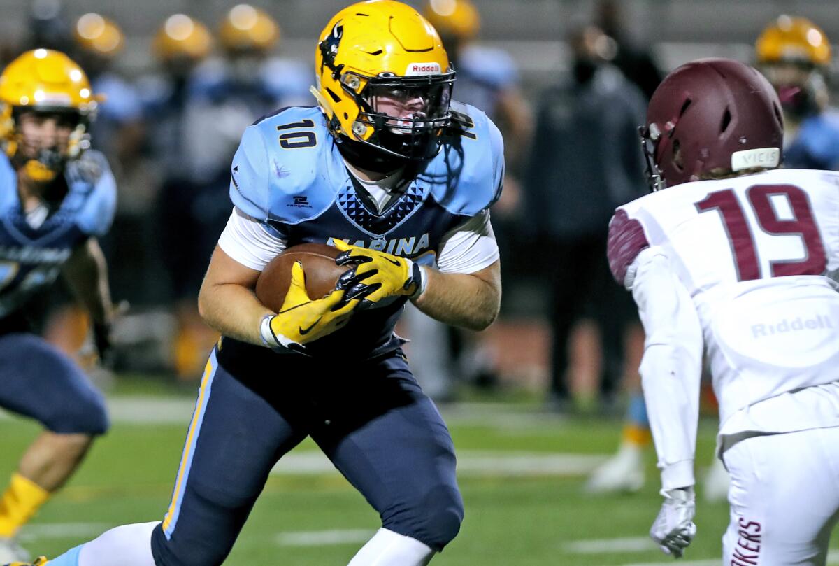 Marina's Wyatt McClour runs with the ball in a home game vs. Laguna Beach at Boswell Field in Westminster on Thursday.