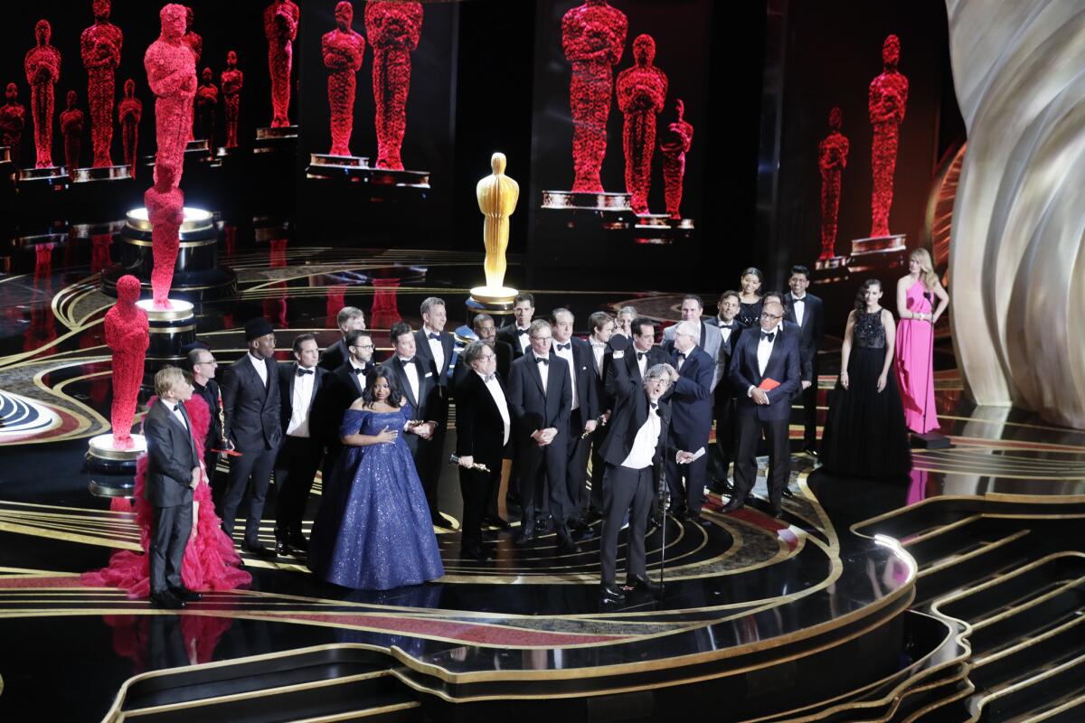 Director Peter Farrelly, center, and the cast of "Green Book" as they win Best Picture during the telecast of the 91st Academy Awards on Sunday.