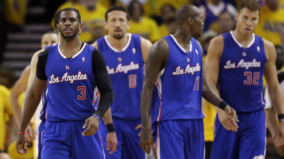 Clippers teammates, from left, Chris Paul, Hedo Turkoglu, Jamal Crawford and Blake Griffin walk back to the bench during the closing minutes of the team's loss to the Golden State Warriors in Game 4 of the Western Conference quarterfinals Sunday.