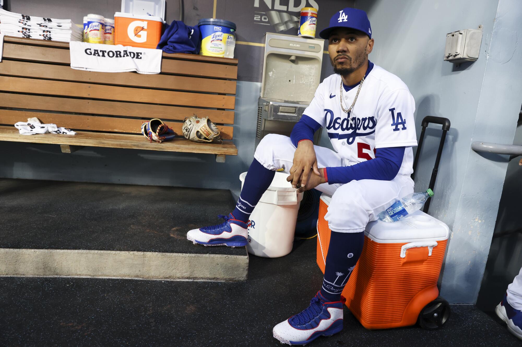 Los Angeles Dodgers right fielder Mookie Betts waits in the dugout before game one of the NLDS.