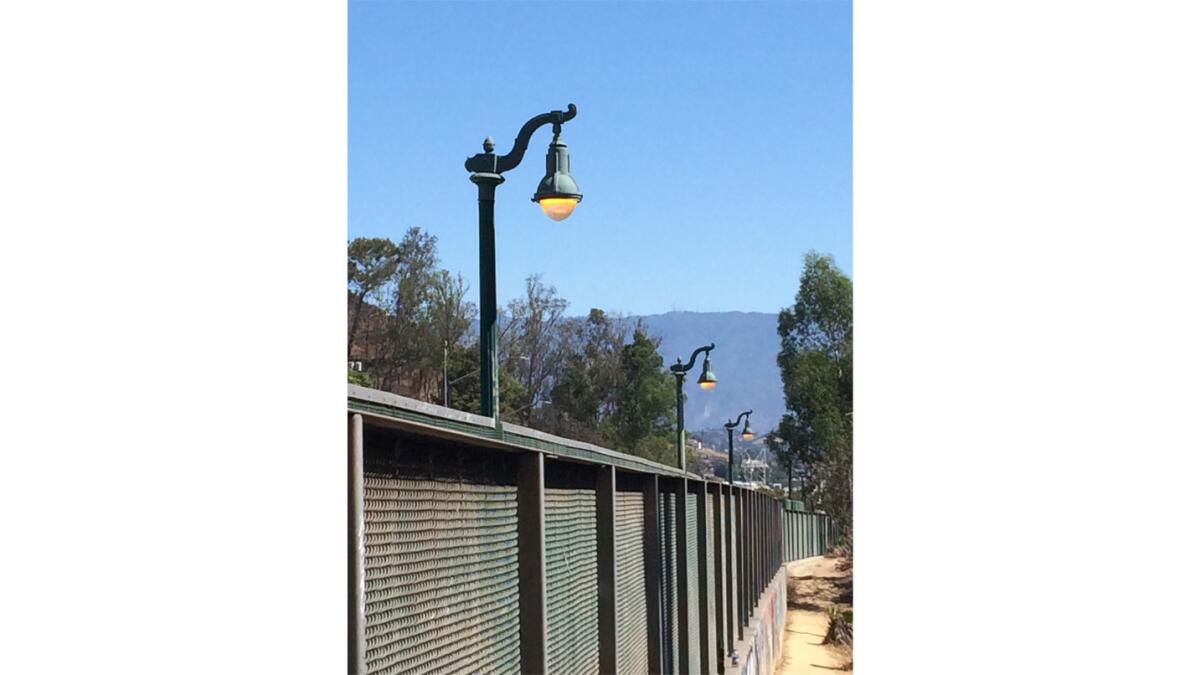 These faux beaux-arts gas lights have been burning 24/7 for about two weeks along the Pasadena Freeway.