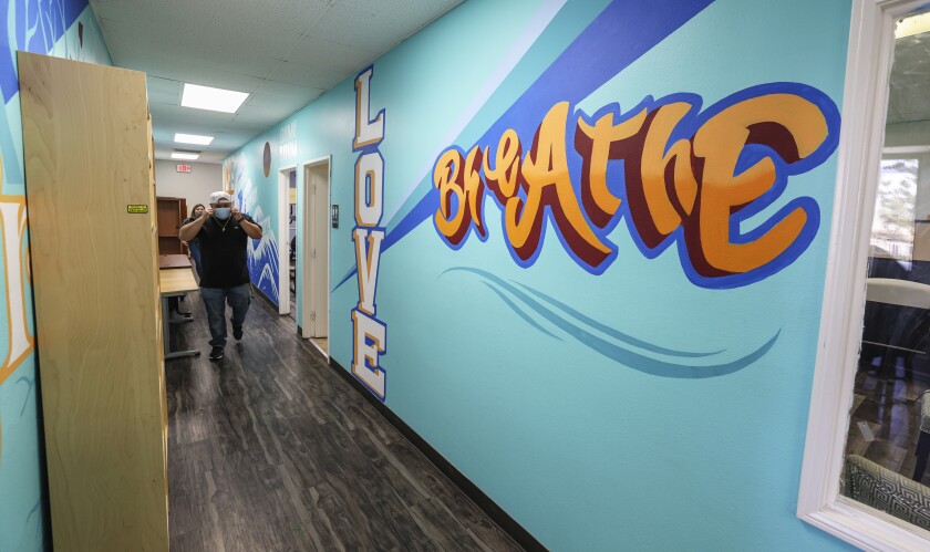 A mural at the Oasis Clubhouse says "Love" and "Breathe."