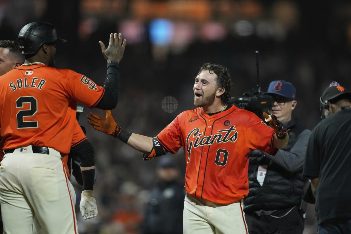 San Francisco's Brett Wisely celebrates with teammate Jorge Soler after his walk-off home run Friday.
