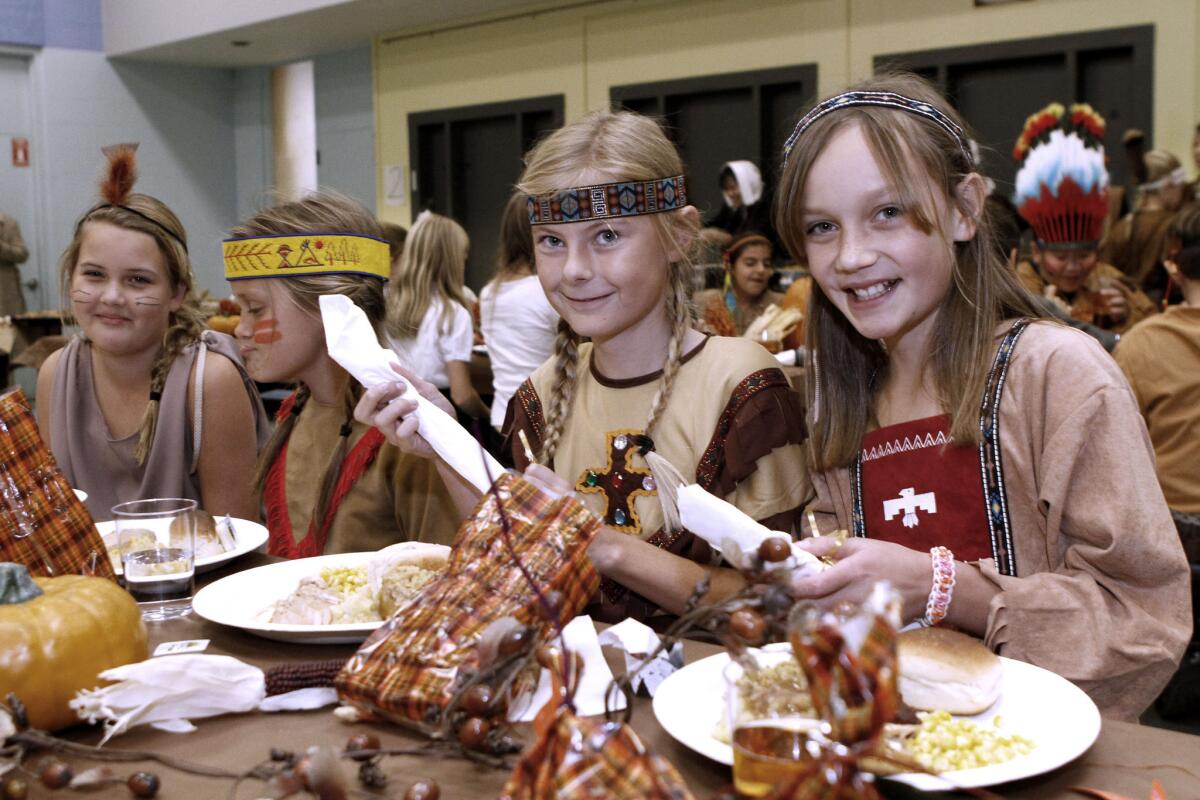 Dresses as indians, from left to right are, Devyn Cox, Haley Decker, Sophie Clarkson and Emily Strauss before enjoying a Thanksgiving feast at La Canada Elementary School in La Canada Flintridge on Friday, Nov. 22, 2013.