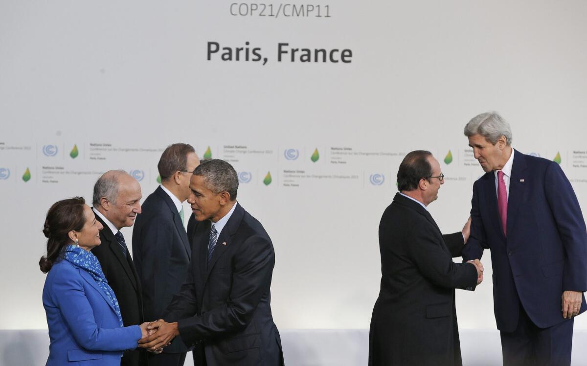 President Obama is greeted by Segolene Royal, left, French minister for ecology, sustainable development and energy, and Secretary of State John Kerry is greeted by French President Francois Hollande as they arrive in Paris on Nov. 30 for the climate change conference.