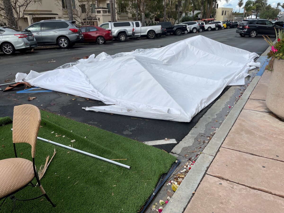 The tent over the outdoor eating area at Sammy’s restaurant at Pearl Street and Draper Avenue toppled in high winds.