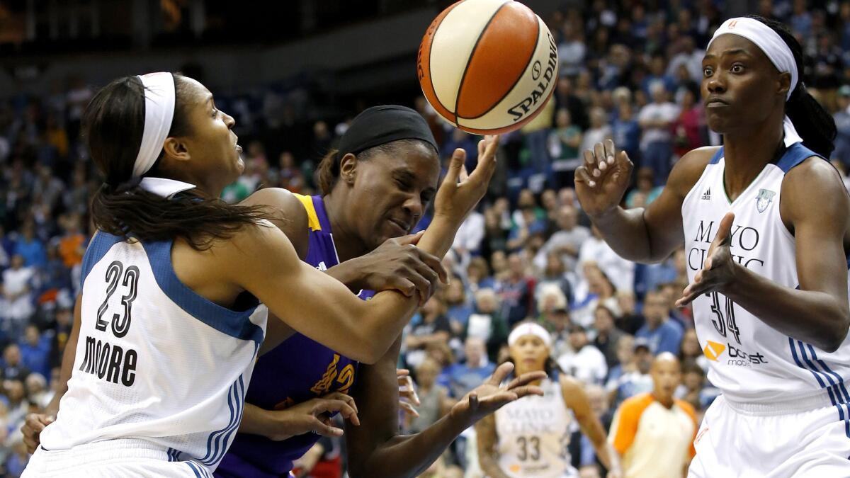 Lynx forward Maya Moore (23) knocks a rebound away from Sparks center Jantel Lavender during the first half of their WNBA playoff opener on Friday night in Minneapolis.