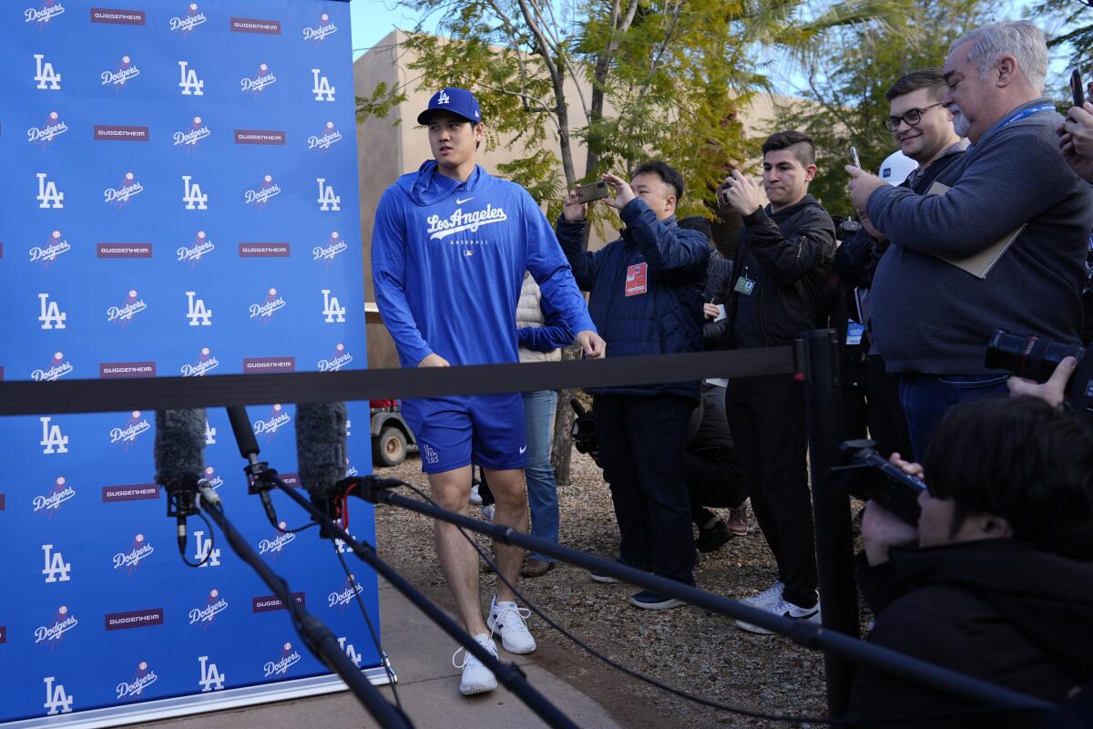 Shohei Ohtani arrives to speak to reporters at Camelback Ranch in Phoenix on Friday.