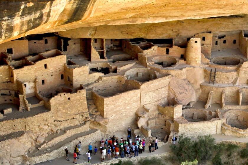 A ranger leads a group of visitors on a tour. These miniature cities carved into the cliffs were originally inhabited by the Ancestral Pueblo people (also known as Anasazi) between 550 and 1200.