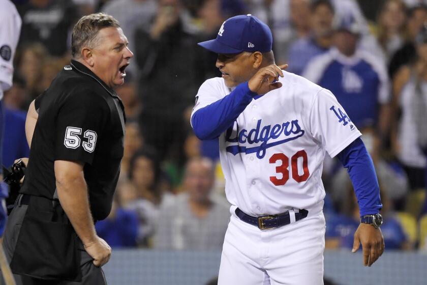 Los Angeles Dodgers manager Dave Roberts, right, argues with home plate umpire Greg Gibson after being ejected during the fourth inning of the team's baseball game against the Colorado Rockies on Friday, Sept. 20, 2019, in Los Angeles. (AP Photo/Mark J. Terrill)