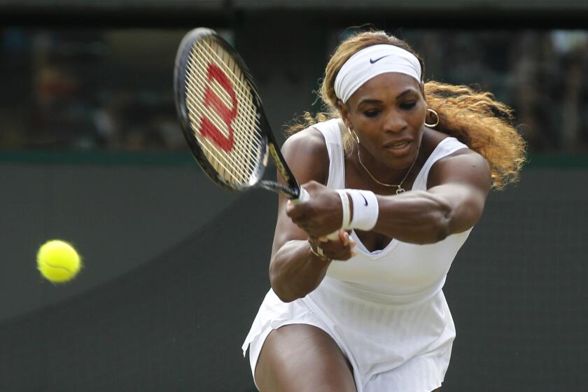 Serena Williams returns to Alize Cornet of France during a women's singles match at the All England Lawn Tennis and Croquet Club in Wimbledon, England. Williams was upset by Cornet, 1-6, 6-3, 6-4.