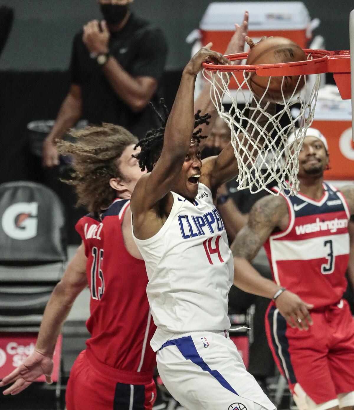 Clippers guard Terance Mann slam dunks over Washington Wizards center Robin Lopez.