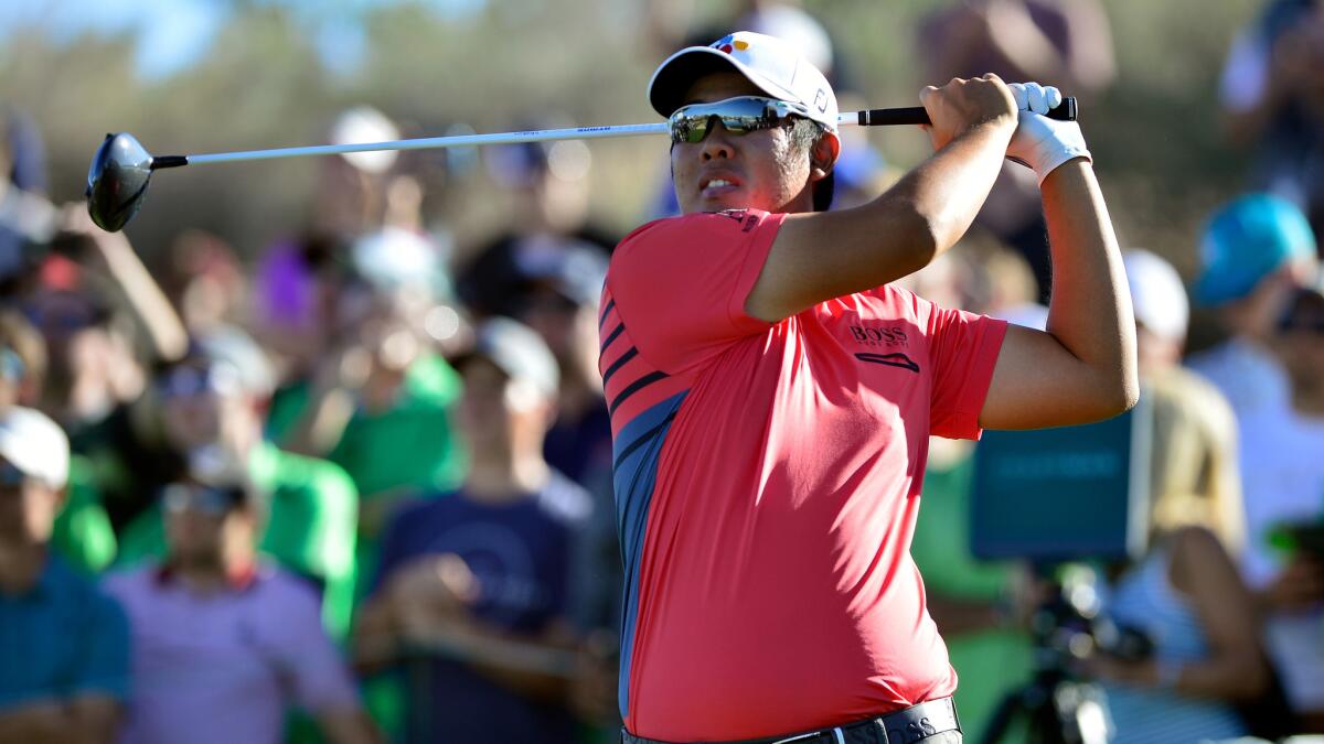 Byeong Hun An follows through on his tee shot at No. 18 during the third round of the Waste Management Phoenix Open.