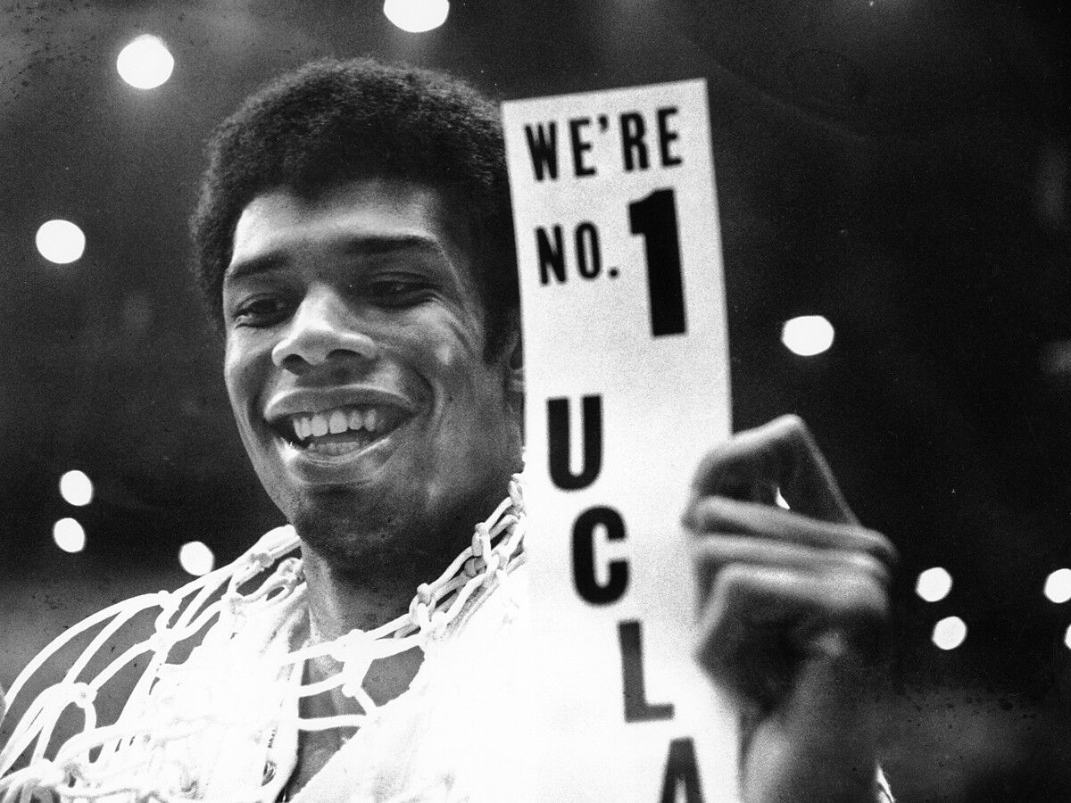 FILE - In this March 23, 1968, file photo, UCLA's Lew Alcindor, with the basket netting draped over his shoulders,  