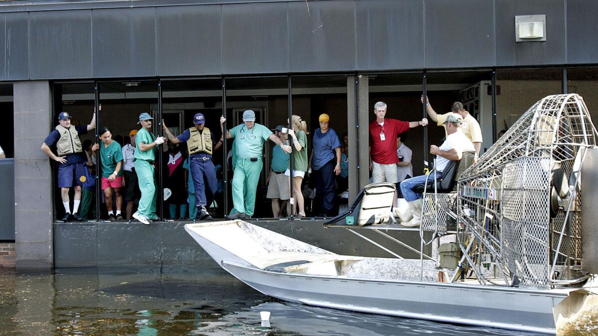 An airboat pulls up to Memorial Medical Center in New Orleans on Aug. 31, 2005, two days after Katrina came ashore. Volunteers in boats were among the first help to arrive, evacuating patients and staff. Later, private helicopters ferried more patients out.