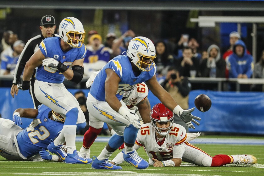 The Chargers' Joey Bosa (97) sacked Patrick Mahomes and caused the Chiefs to fumble as Jerry Tillery pursues the loose ball.