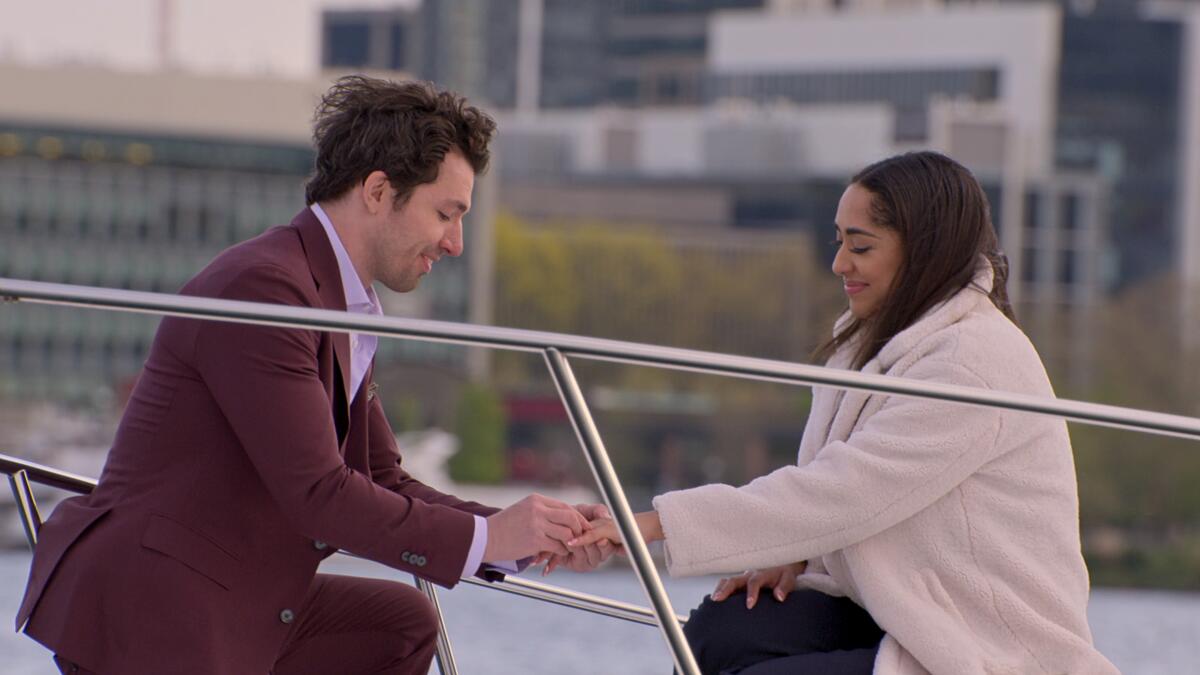 A man proposes to a woman on boat