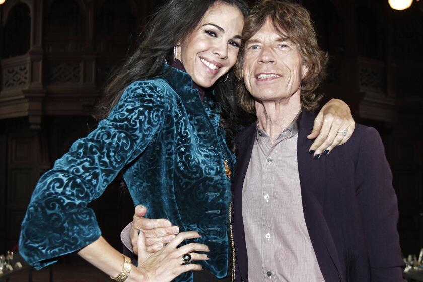 Designer L'Wren Scott is shown with her longtime boyfriend, the Rolling Stones' Mick Jagger. Scott was found dead in New York on Monday.