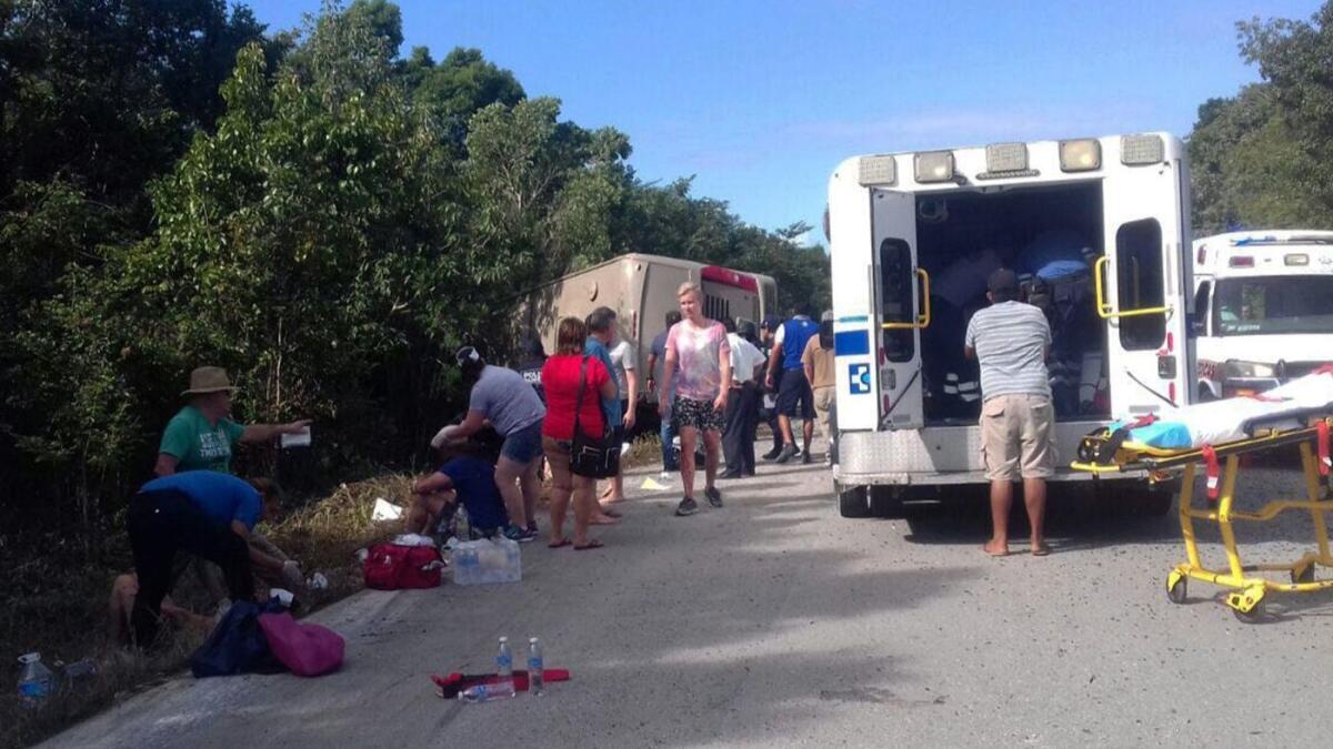 People receive medical attention after a bus crash near Mahahual, Mexico, on Tuesday.