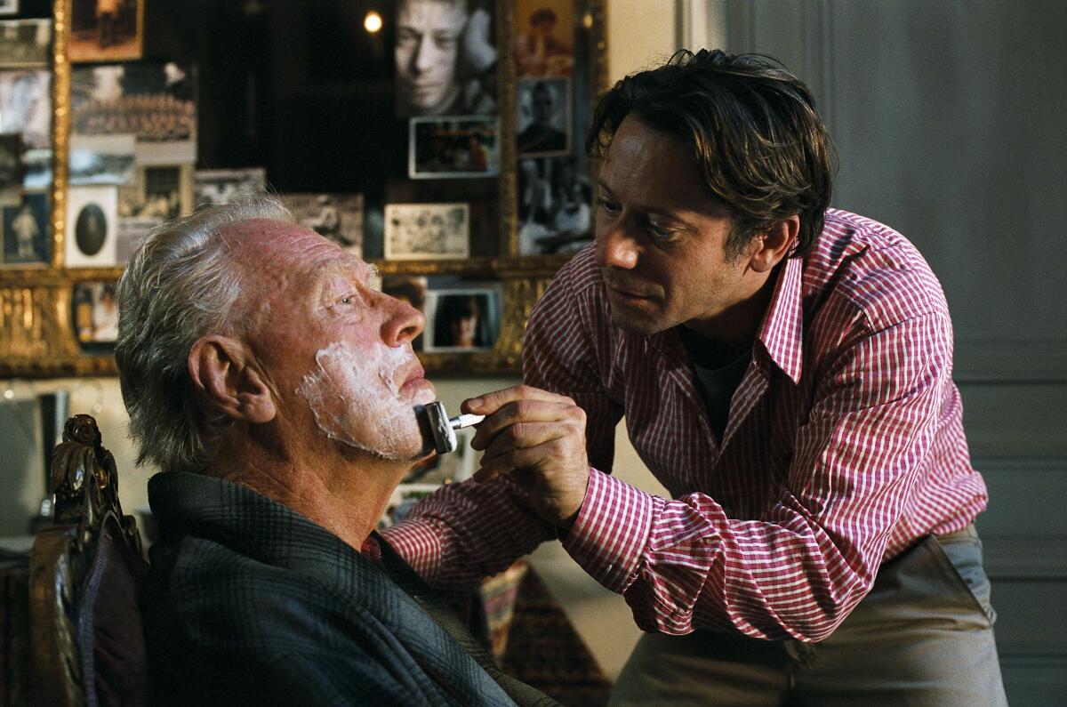  Mathieu Amalric, right, shaving Max Von Sydow in a scene from "The Diving Bell And The Butterfly."