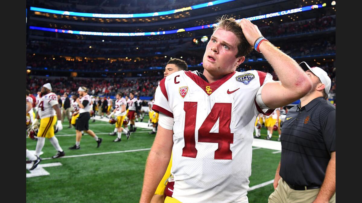 USC quarteraback Sam Darnold walks off the field after losing to Ohio State in the Cotton Bowl on Friday night.