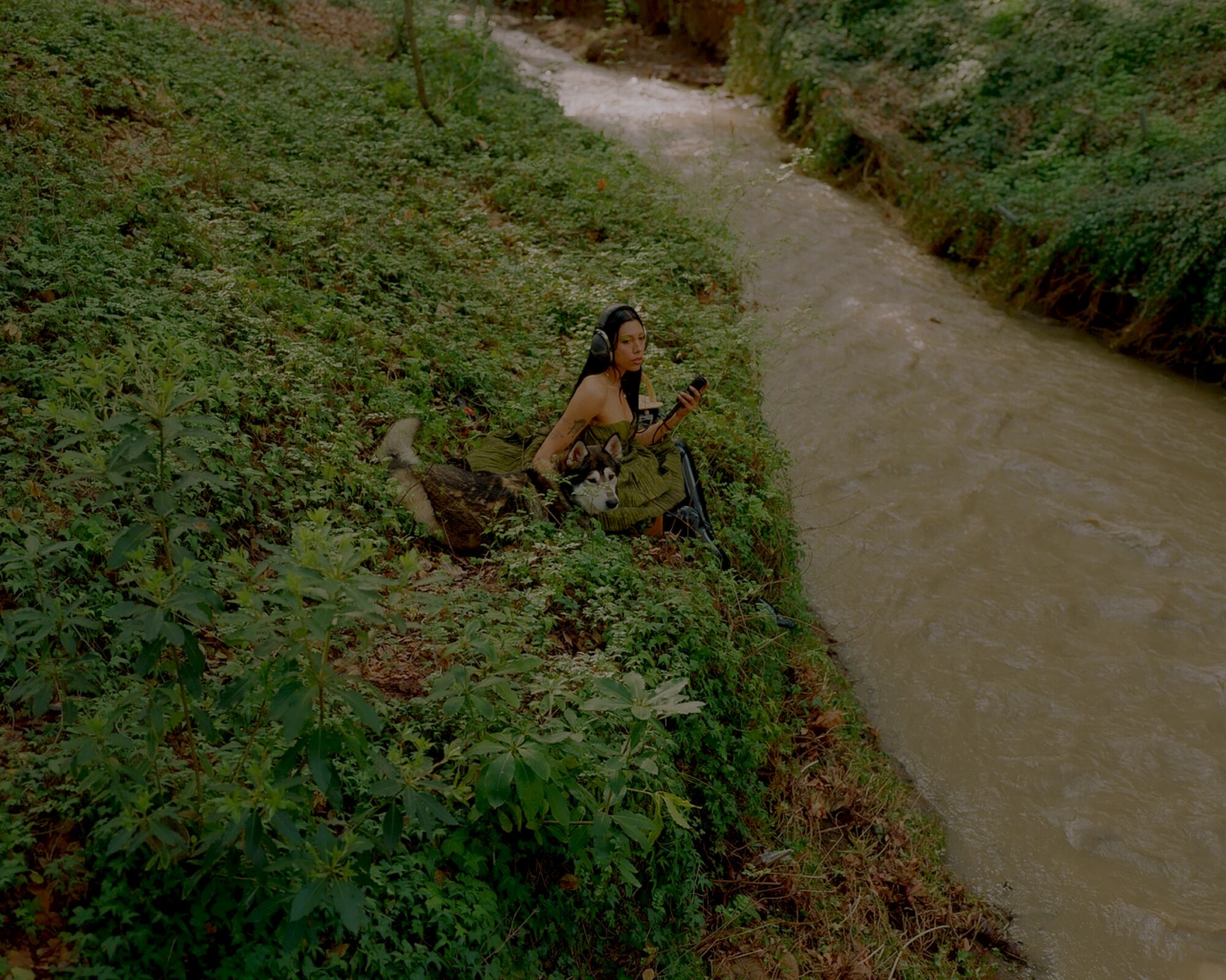 Mia Carucci and their dog Larry near the river.