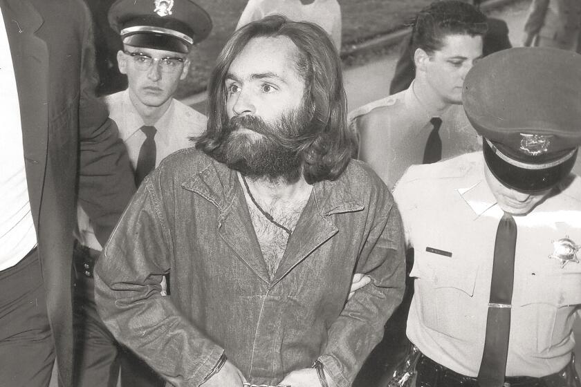 Charles Manson is escorted into court for a hearing Dec. 3, 1969. 