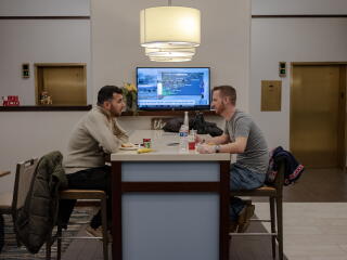 Abdulhaq Sodais, left, and Spencer Sullivan right have breakfast at a hotel in Skokie, Ill.