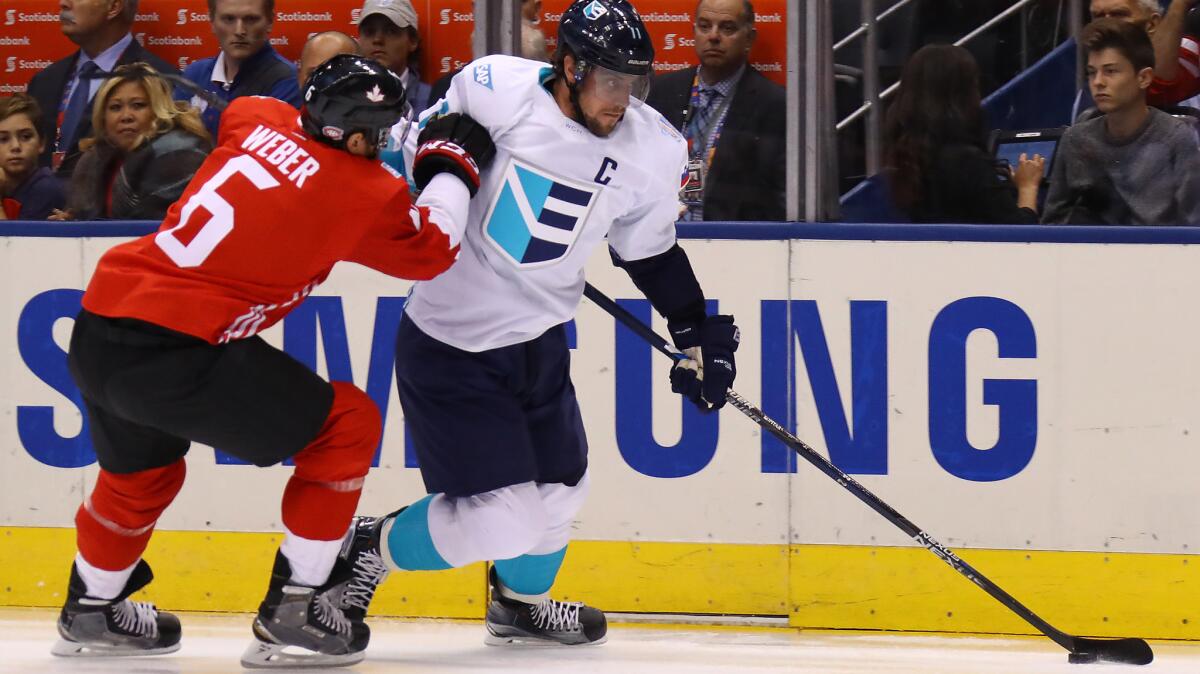 Team Europe's Anze Kopitar, right, is defended by Team Canada's Shea Weber on Sept. 27.