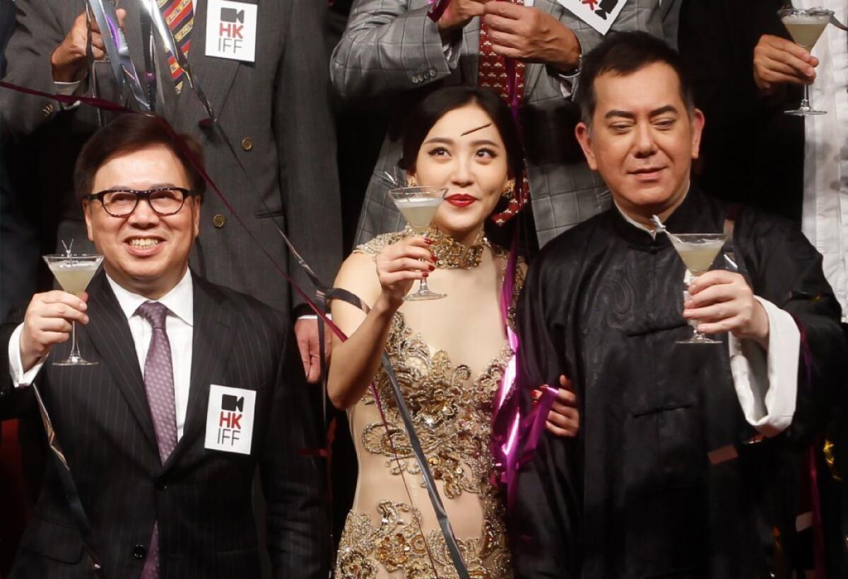Hong Kong International Film Festival Society Chairman Wilfred Wong, left, Chinese actress Zhou Chu Chu, center, and Hong Kong actor Anthony Wong raise glasses during the opening ceremony of 37th Hong Kong International Film Festival.