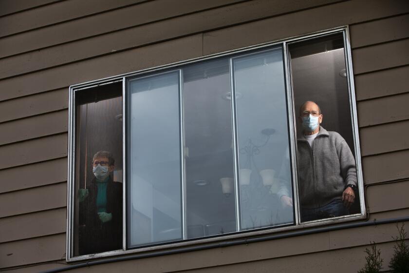 Pat and Bob McCauley, have quarantined themselves at their home in Kirkland, Wash. on March 10, 2020. Their good friend, a Life Care resident, died on Sunday of COVID-19. They are mourning him, and anxiously waiting for the results of their own COVID-19 tests. They must wear masks when they around each other. Otherwise they need to stay in separate bedrooms and bathrooms in the house. (photo by Karen Ducey)