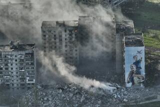 FILE - Smoke rises from a building in Bakhmut, the site of the heaviest battles with the Russian troops in the Donetsk region, Ukraine, Wednesday, April 26, 2023. Ukrainian President Volodymyr Zelenskyy said Sunday, May 21, 2023 that Russian forces weren't occupying Bakhmut, casting doubt on Moscow's insistence that the eastern Ukrainian city had fallen. The fog of war made it impossible to confirm the situation on the ground in the invasion’s longest battle, and the comments from Ukrainian and Russian officials added confusion to the matter. (AP Photo/Libkos, File)