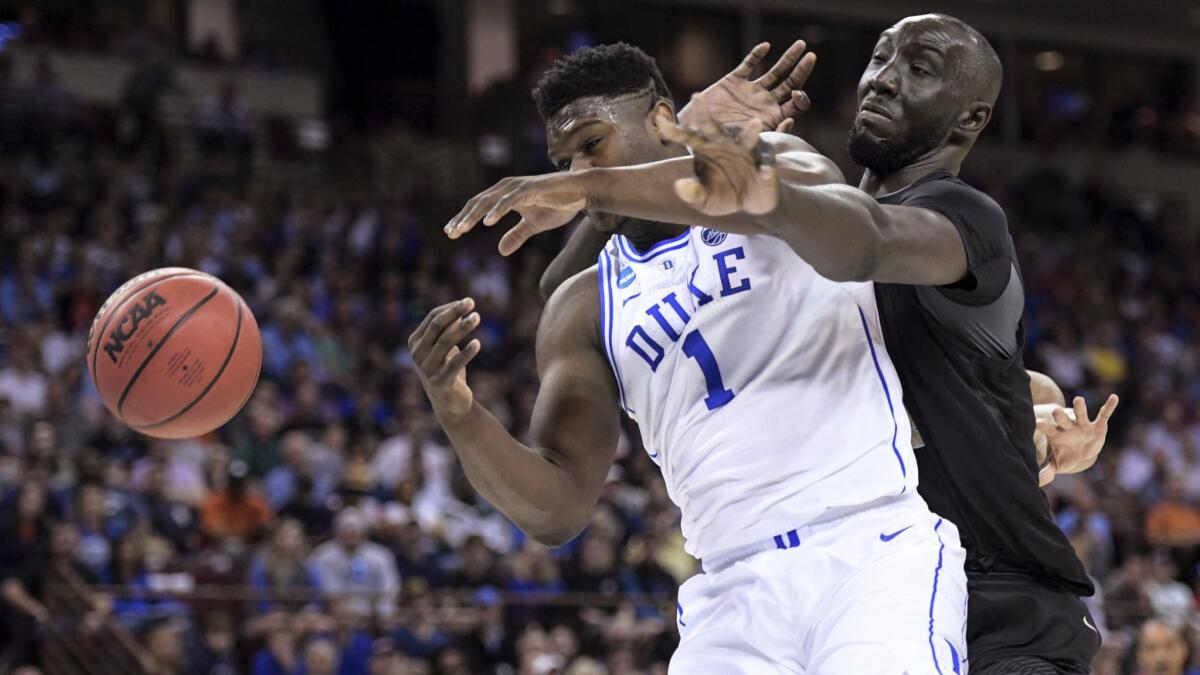 Central Florida center Tacko Fall, right, defends against Duke forward Zion Williamson during the first half of the Blue Devils' win in the second round of the NCAA tournament on Sunday.