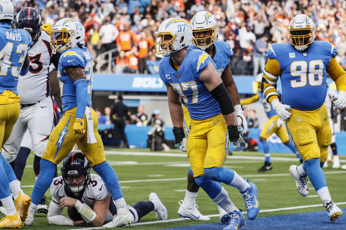 The Chargers' Joey Bosa (97) celebrates after stopping Broncos quarterback Drew Lock (3) at the goal line in the first half.