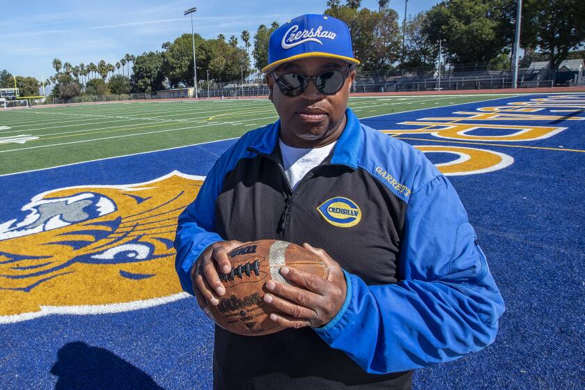 Robert Garrett, head coach of the Crenshaw High School varsity football team, is photographed.