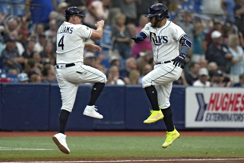 Tampa Bay Rays' Harold Ramirez, celebrates his two-run home run with third base coach Brady Williams (4) off Minnesota Twins starting pitcher Bailey Ober during the fourth inning of a baseball game Thursday, June 8, 2023, in St. Petersburg, Fla. (AP Photo/Chris O'Meara)