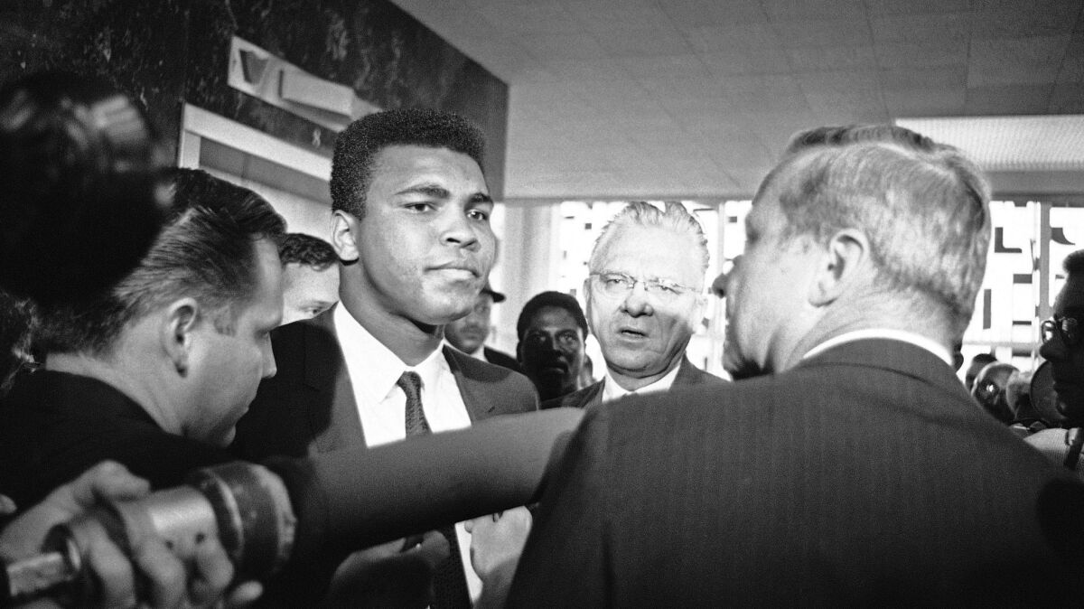 Muhammad Ali with his chief attorney Hayden Covington, right, on June 19, 1967, in Houston, as the boxing champion goes to trial on charges of refusing to be inducted into the armed services.