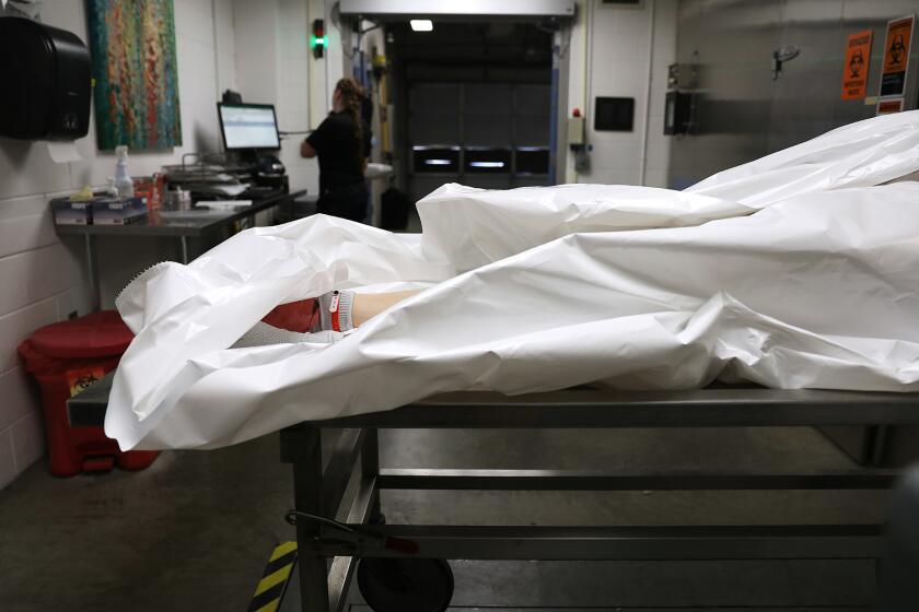 A body is processed at the Pierce County Medical Examiner's office in Tacoma, Washington. (Christina House / Los Angeles Times)