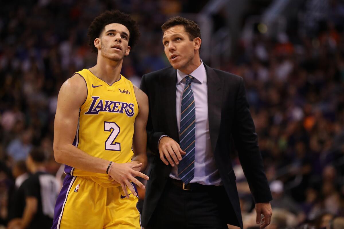Lakers coach Luke Walton chats with guard Lonzo Ball during a game in October.