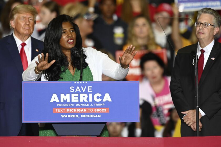 FILE - Former President Donald Trump, left, and Michigan Republican attorney general candidate Matt DePerno, right, listen as Michigan Republican secretary of state candidate Kristina Karamo addresses the crowd during a rally at the Macomb Community College Sports & Expo Center in Warren, Mich., Saturday, Oct. 1, 2022. Karamo, a community college instructor, ran as a far-right candidate in the 2022 midterms after becoming one of the most prominent election conspiracists in the country. (Todd McInturf/Detroit News via AP, File)