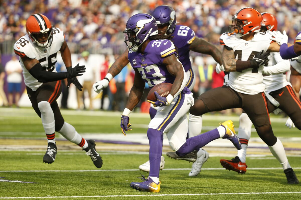 Minnesota Vikings running back Dalvin Cook (33) runs from Cleveland Browns middle linebacker Malcolm Smith (56) during the first half of an NFL football game, Sunday, Oct. 3, 2021, in Minneapolis. (AP Photo/Bruce Kluckhohn)