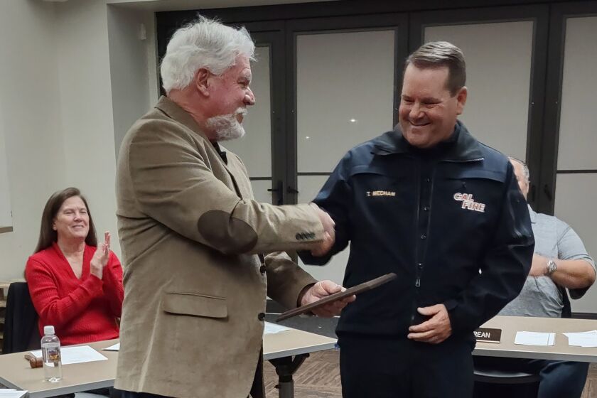Cal Fire and San Diego County Fire Chief Tony Mecham accepts a plaque of appreciation from Dan Summers of the Ramona Community Planning Group on Dec. 1.