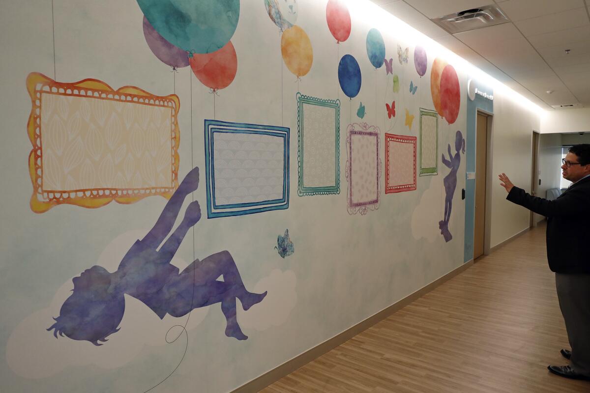 Matthew Lazari, executive director of CHOC Children's Thompson Autism Center, talks about the planning behind the artwork as he gives a tour of the new facility for autistic children.